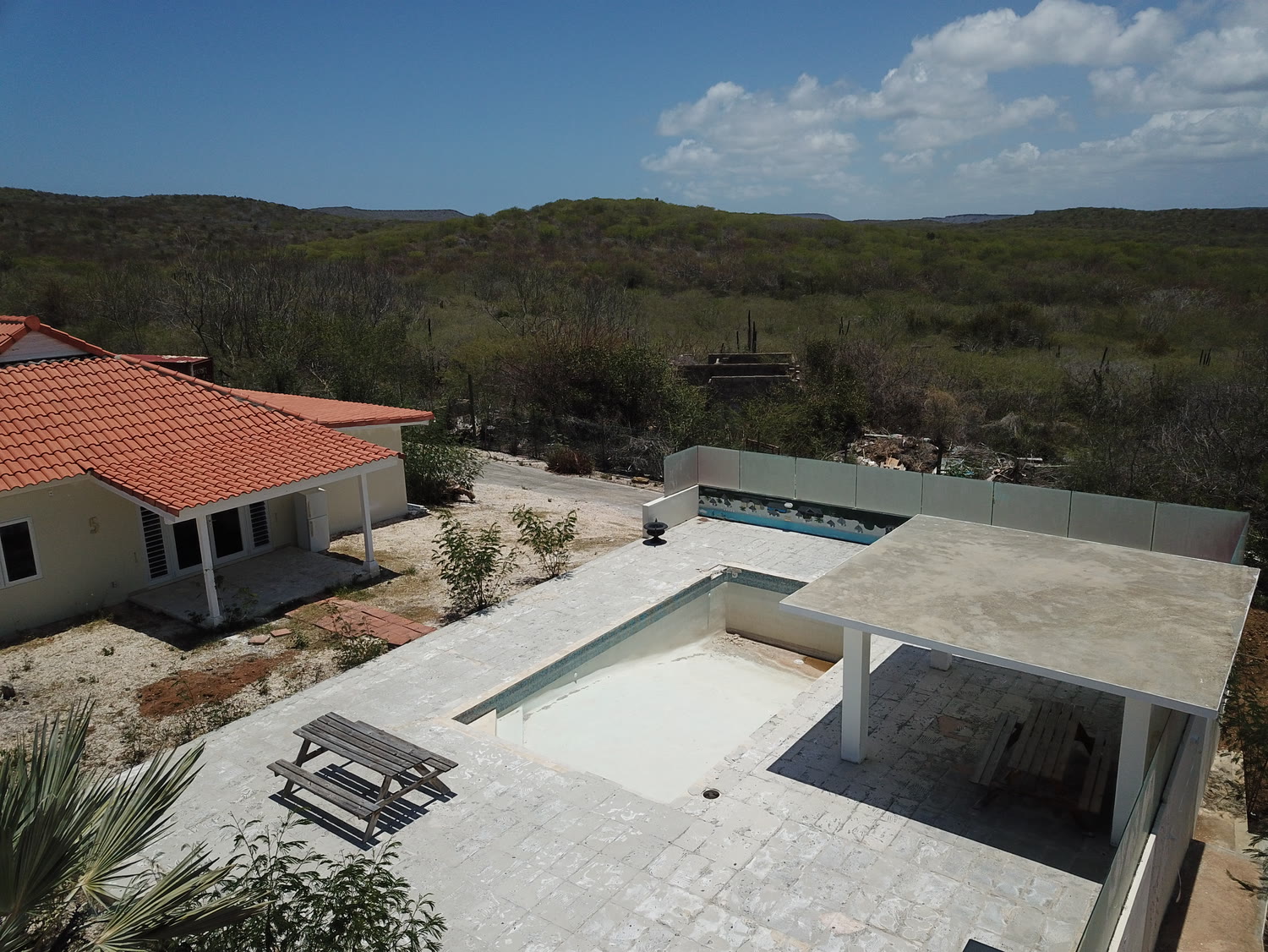 The shared pool under construction between the villas